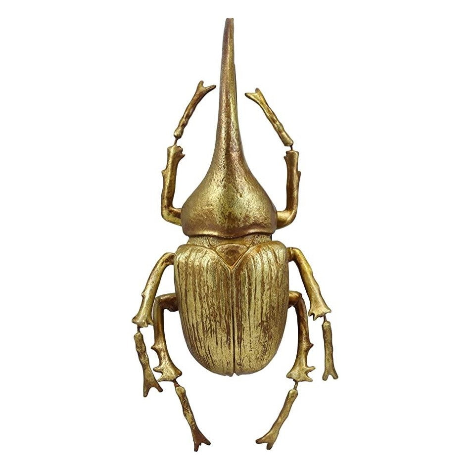 Gold-colored beetle with a long horn, viewed from above.