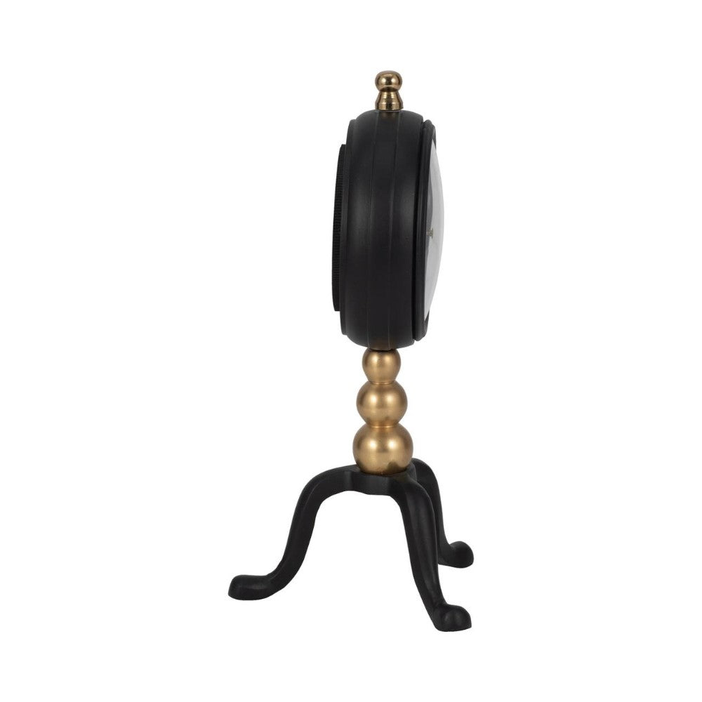 Side view of a decorative clock with a golden stand.