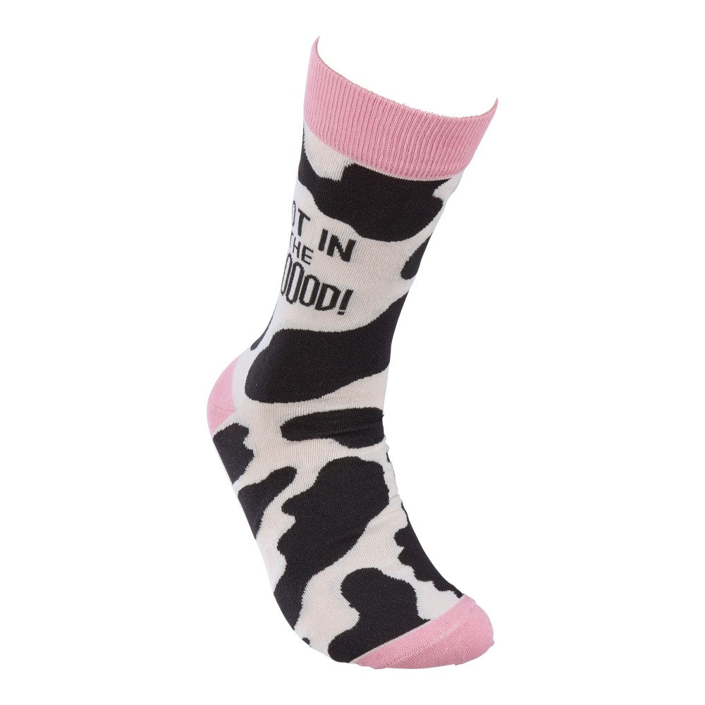 Cow-patterned sock with pink accents and text.