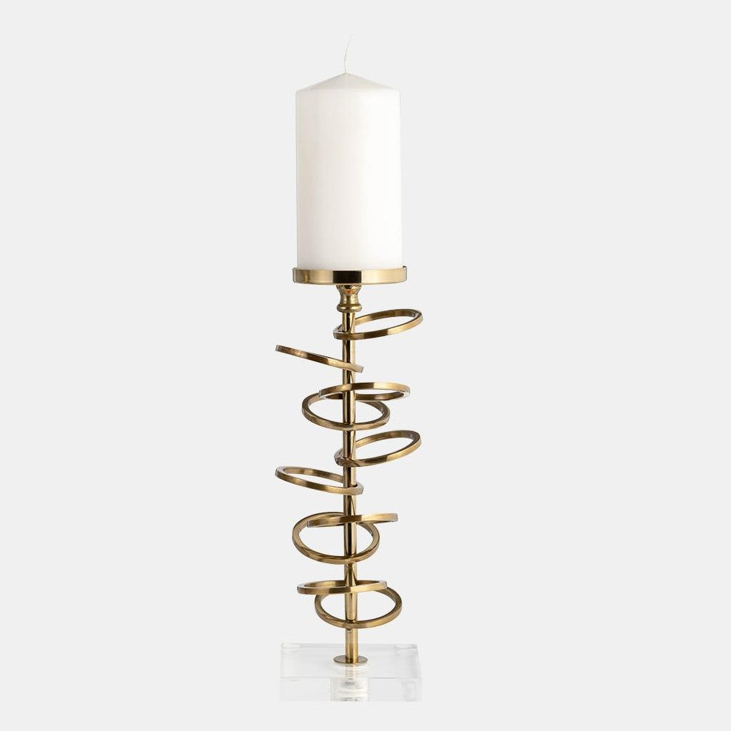 Gold spiral candlestick with white candle on a clear base.
