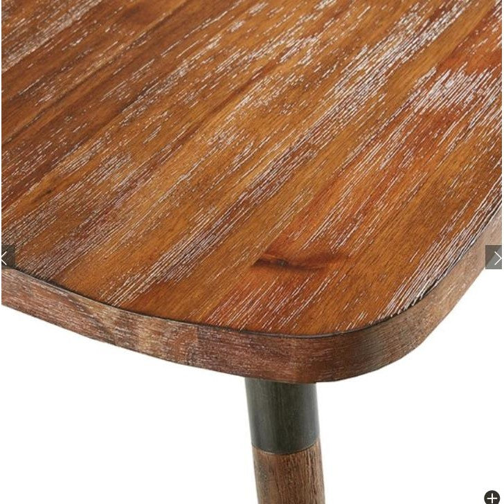 Close-up of a wooden table corner with a rustic, textured finish.