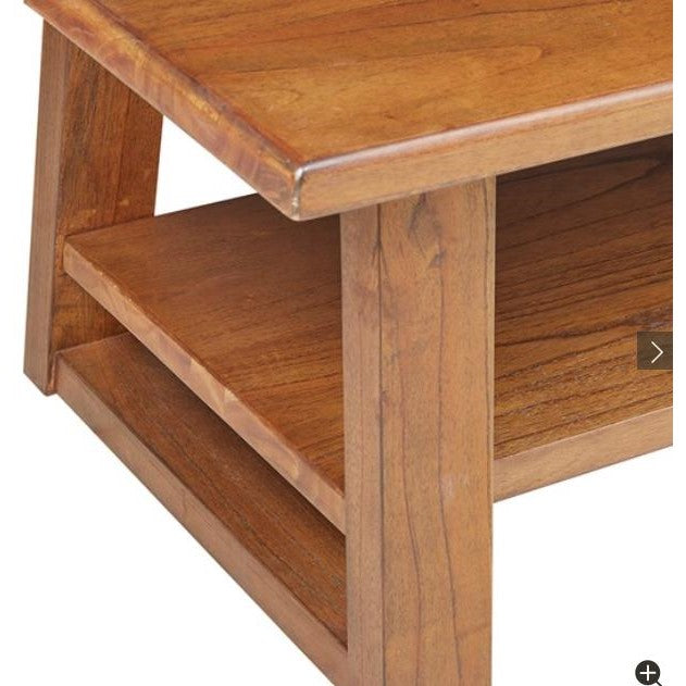 Wooden corner of a table with shelves.