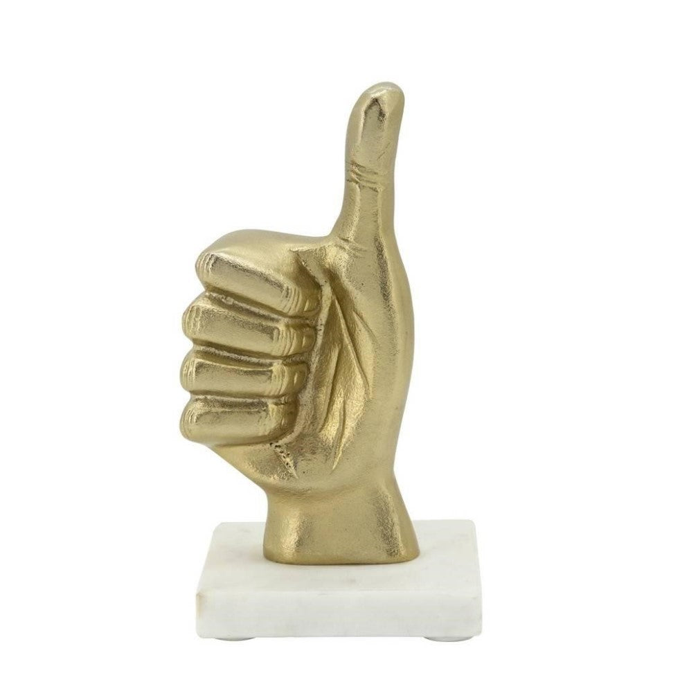 Gold thumbs-up sculpture on a marble base.