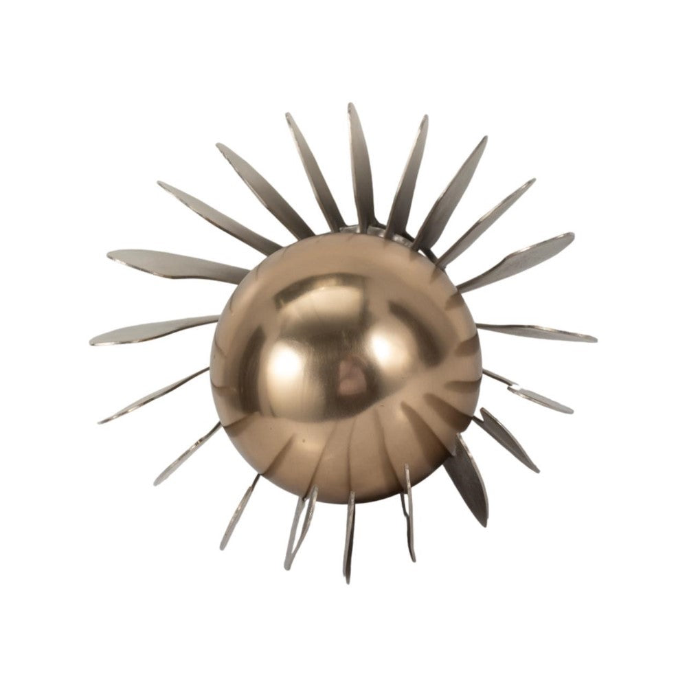Metallic sunburst sculpture with abstract rays.