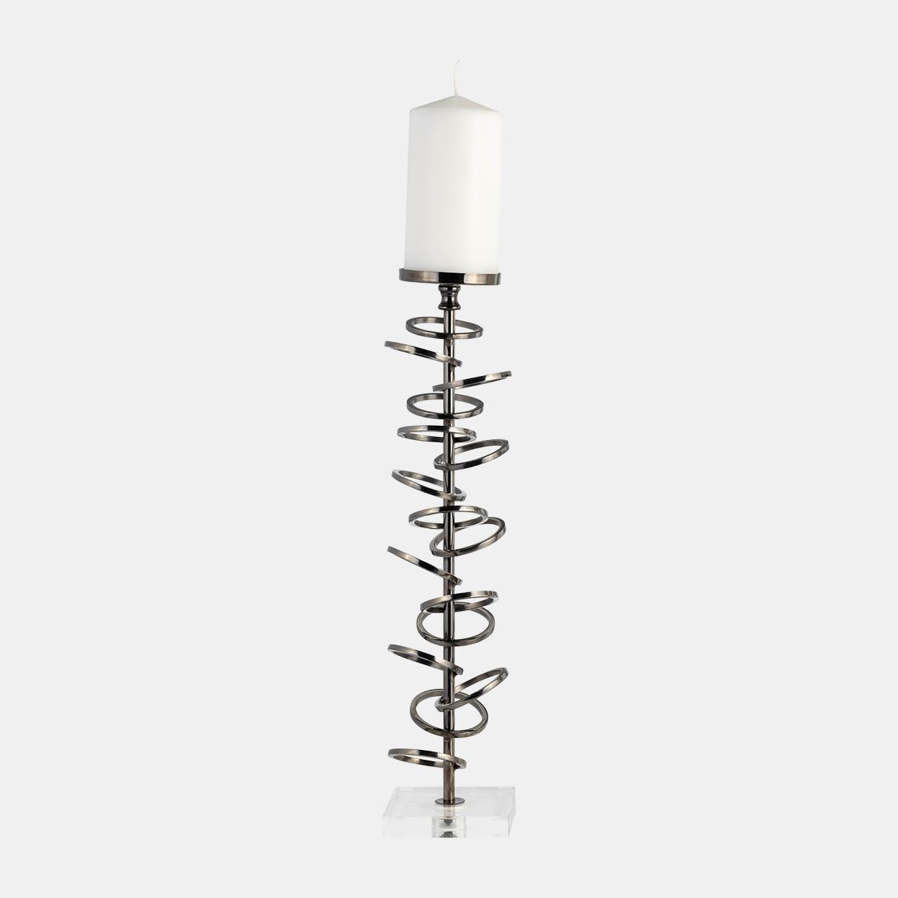 Tall candle holder with spiral design and white candle.