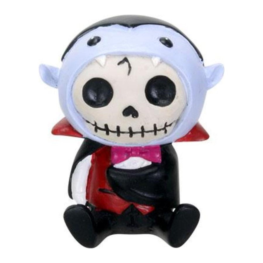 Cute skeleton toy in vampire costume, sitting with a pink bowtie.