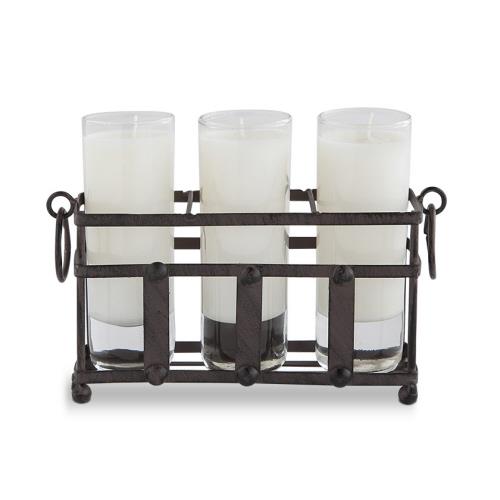 Three white candles in a rustic iron stand.