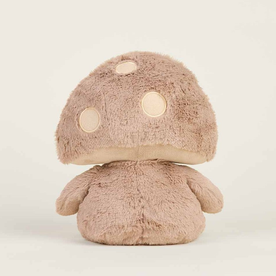 Plush mushroom toy with a fluffy cap and round spots, sitting against a plain background.