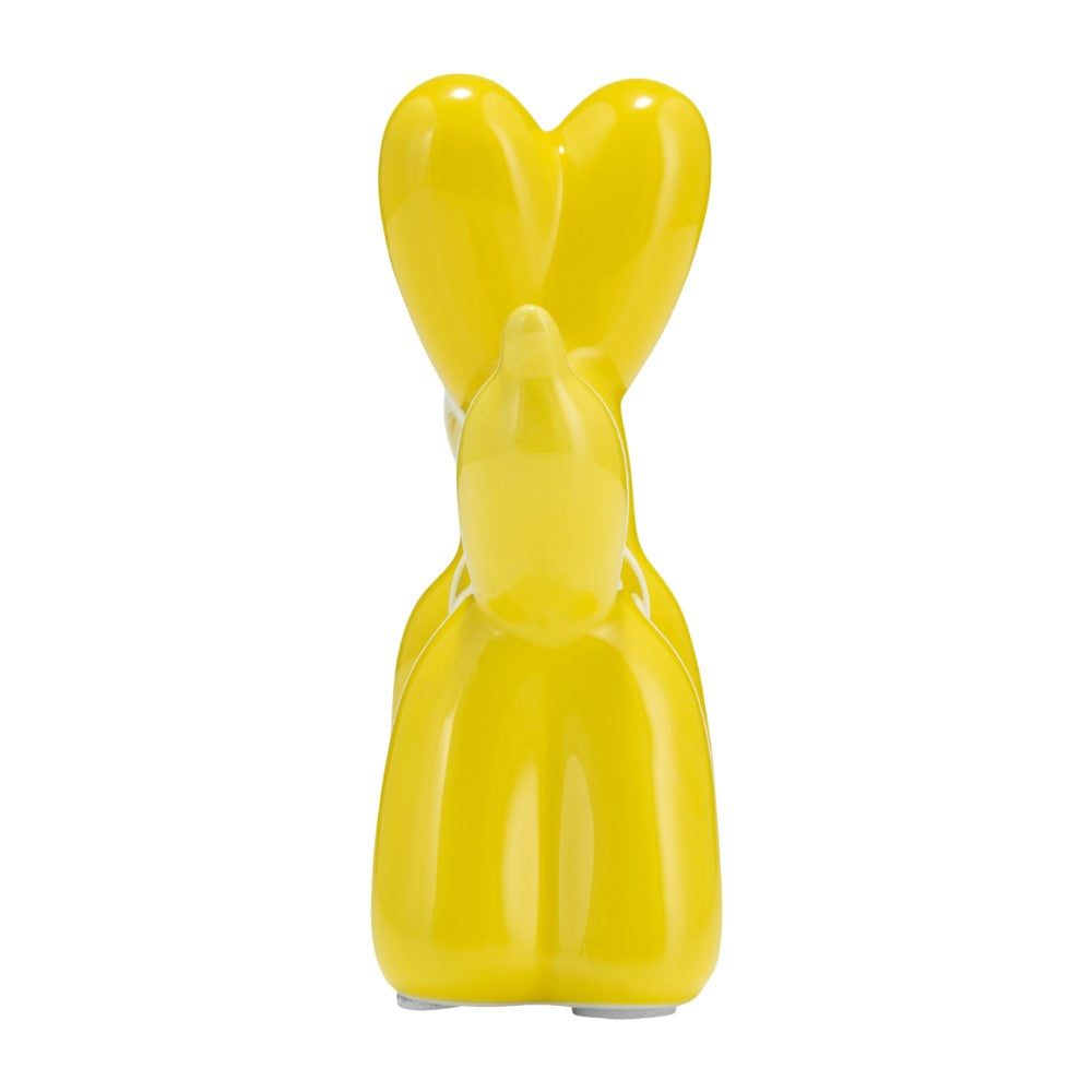 Yellow ceramic bunny-shaped sculpture, rear view, with tall ears.