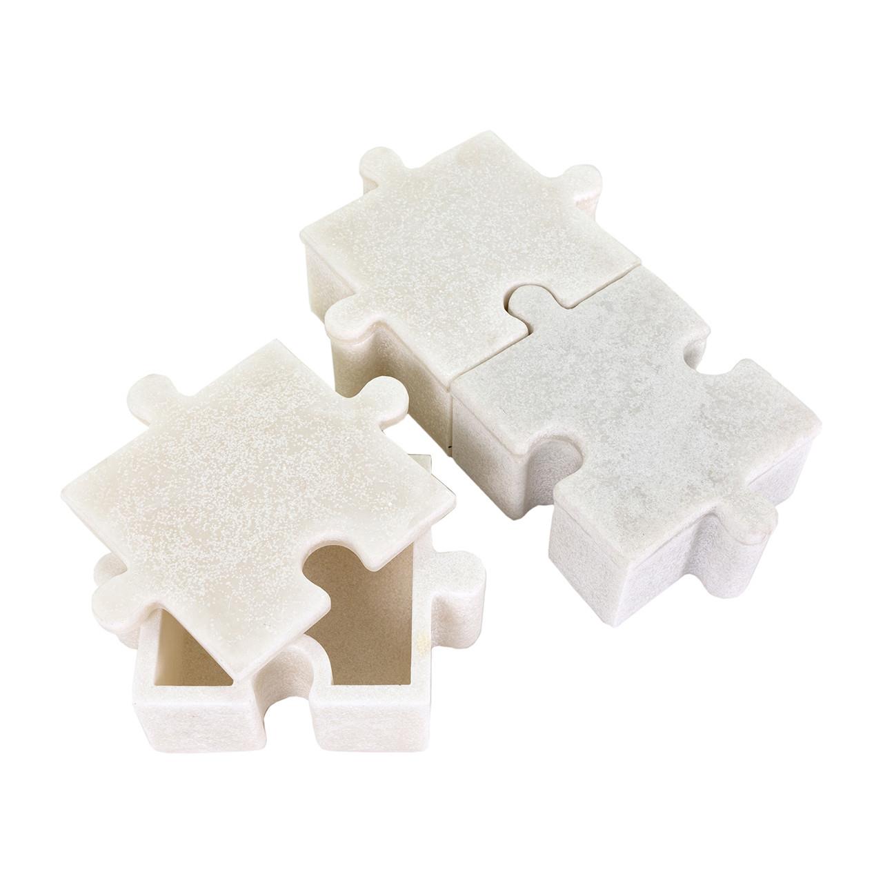Two white puzzle-shaped containers, one open, on a white background.