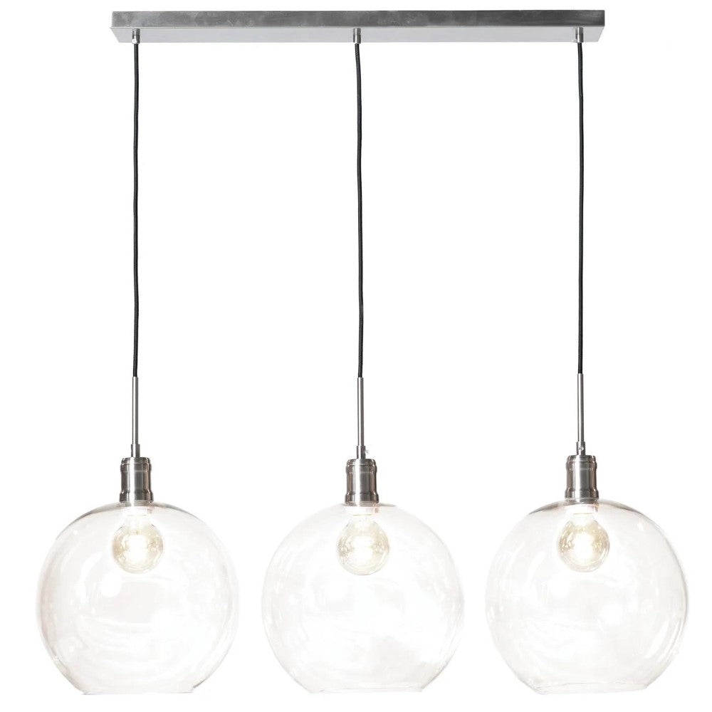 Three hanging clear glass pendant lights.