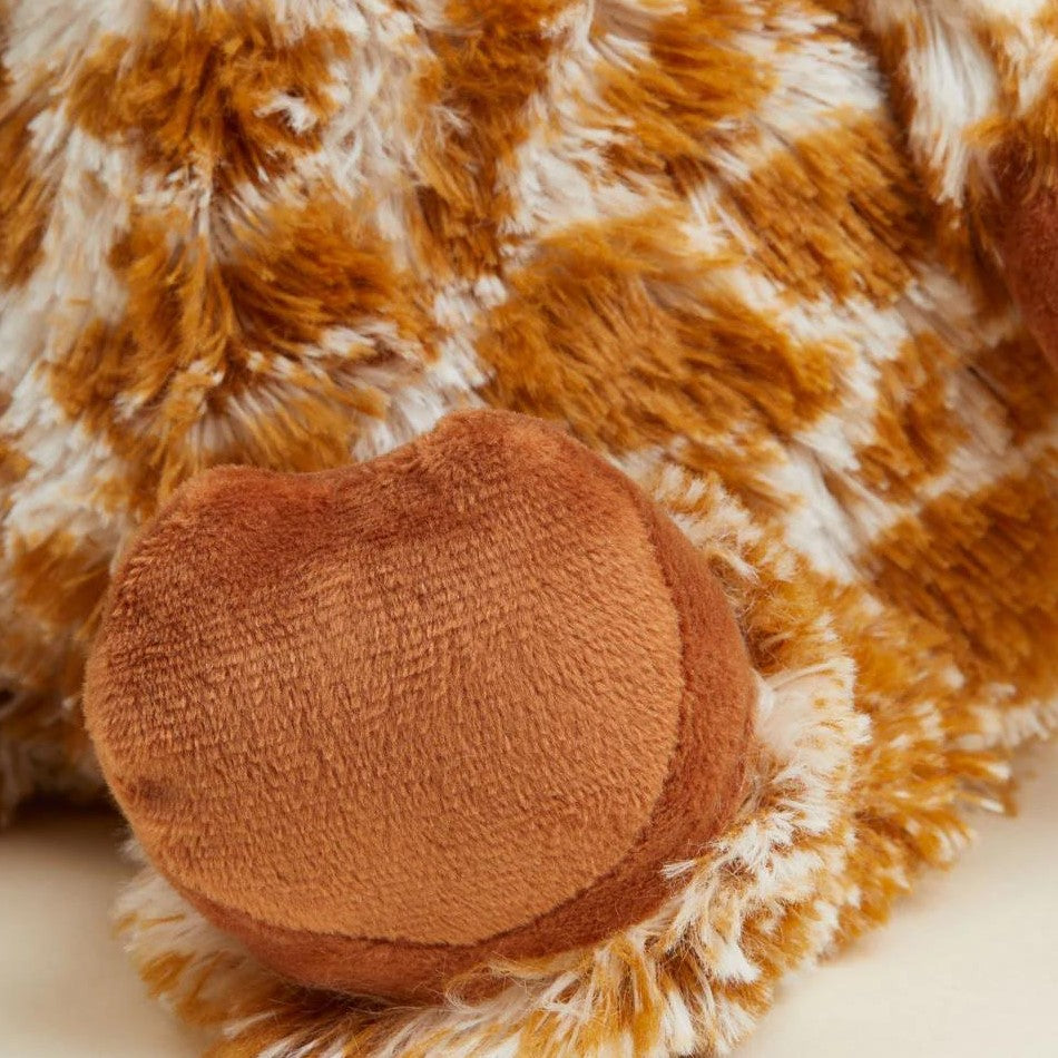 Close-up of a plush, furry toy with a paw in orange and white pattern.
