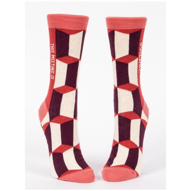 Geometric socks with red, black, and white pattern, humorous text on sides.