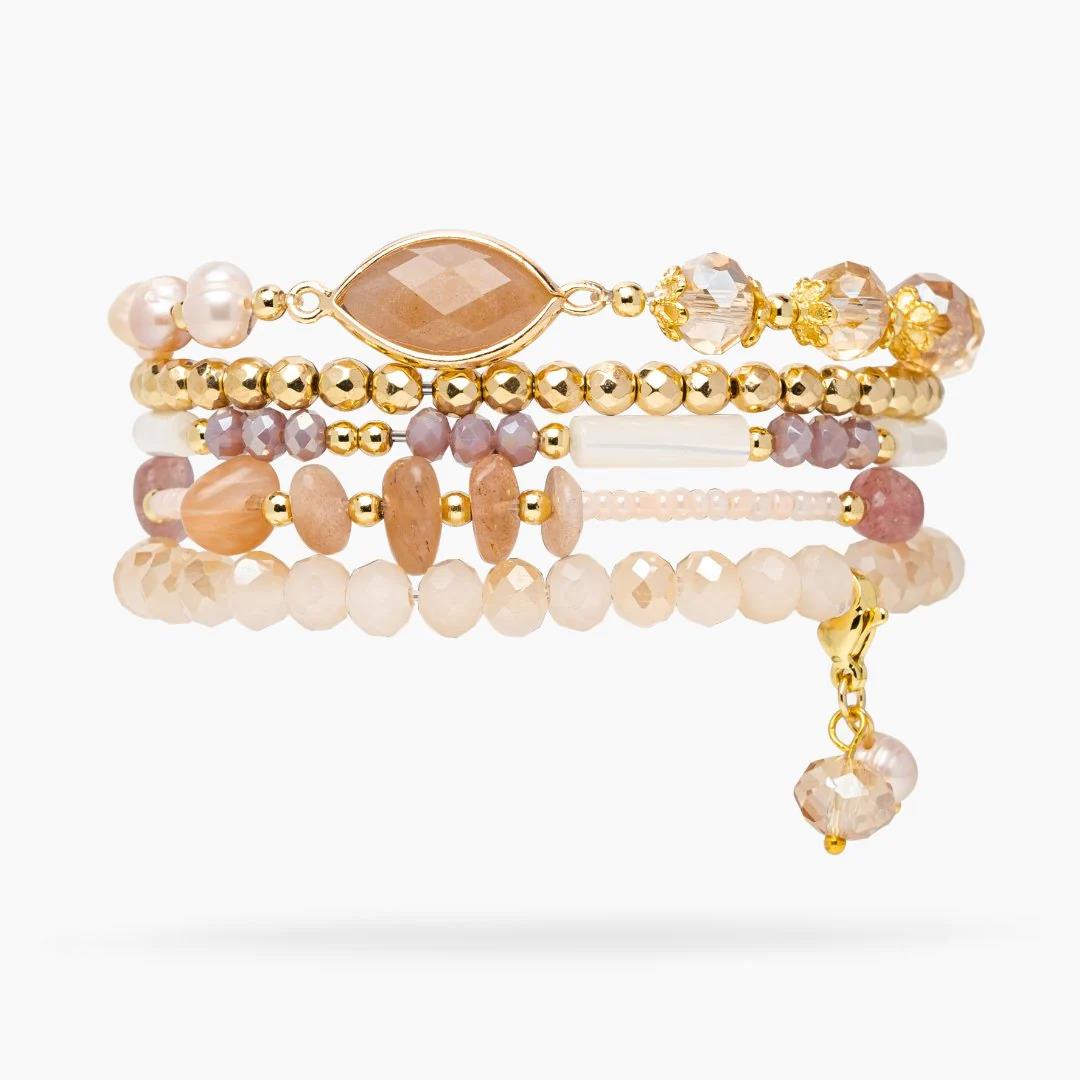 Gold and pastel beaded bracelets with a dangling charm.