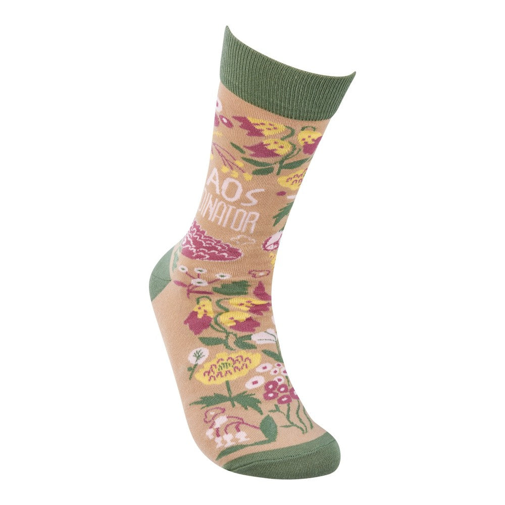 Colorful sock with floral and mushroom patterns, green cuff and toe accents.