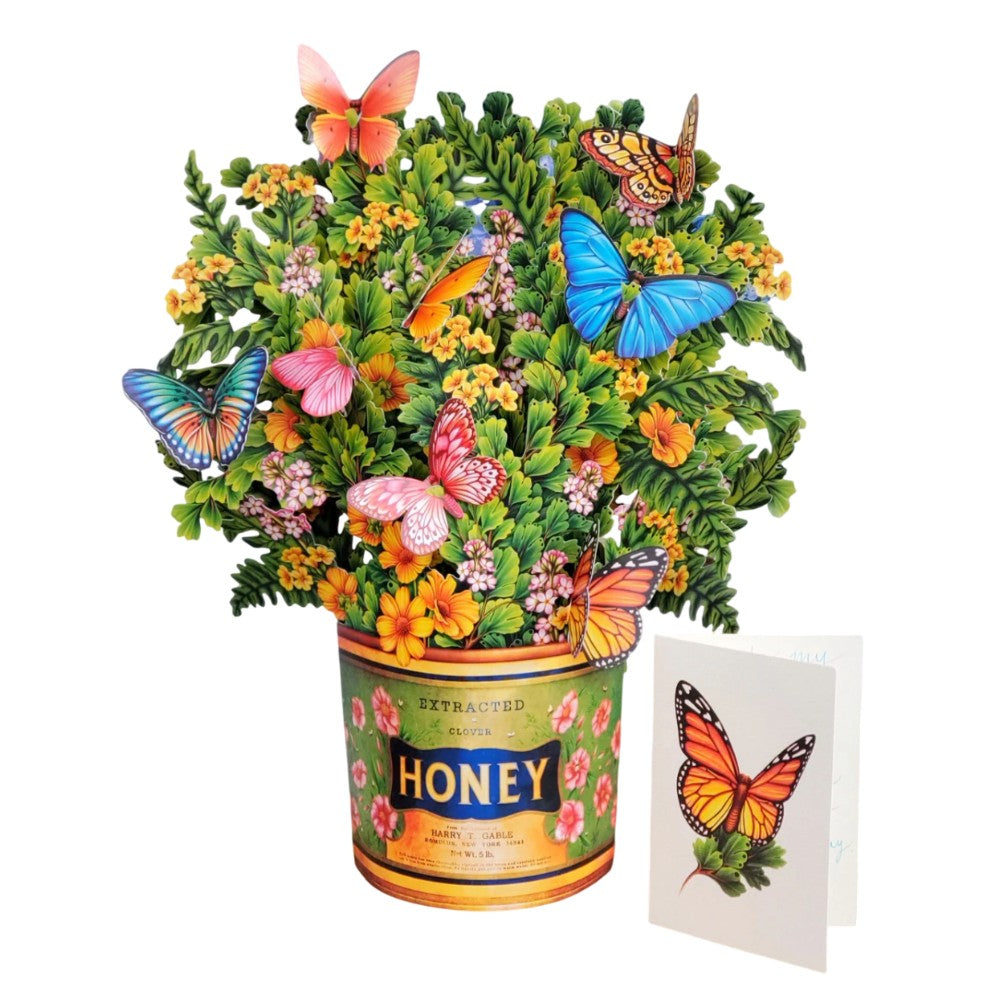 Colorful butterflies and flowers in a honey tin with a butterfly card.