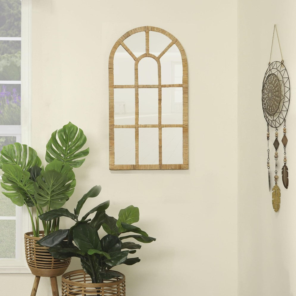 Arched mirror, plants, wall decor in a bright, cozy room.