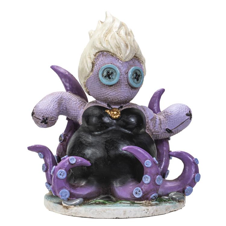 Whimsical octopus figurine with button eyes and a black dress.