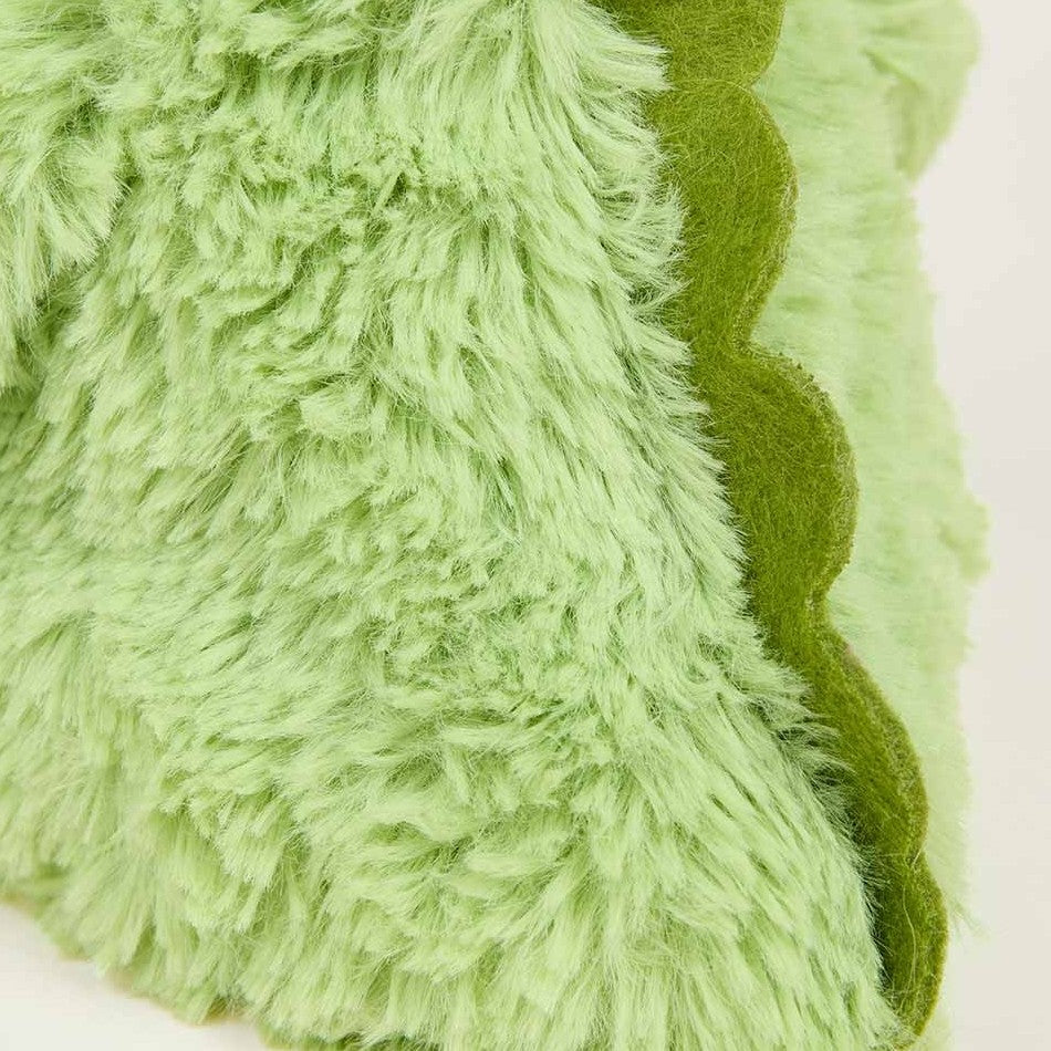Fluffy green fabric with wavy edge.