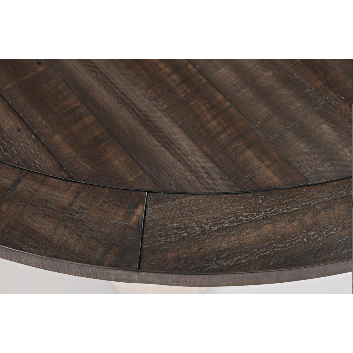 Close-up of a round wooden table with dark brown planks.