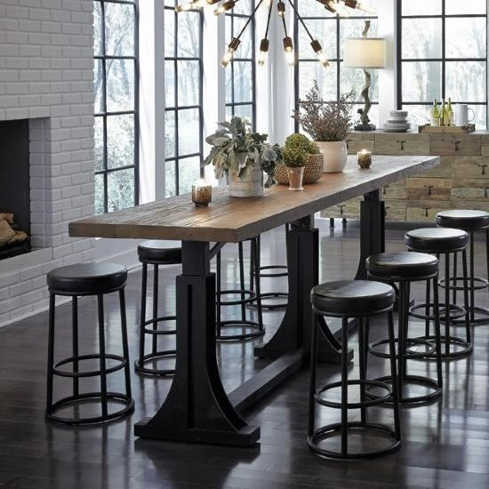 Modern industrial dining area with a wooden table and black stools.
