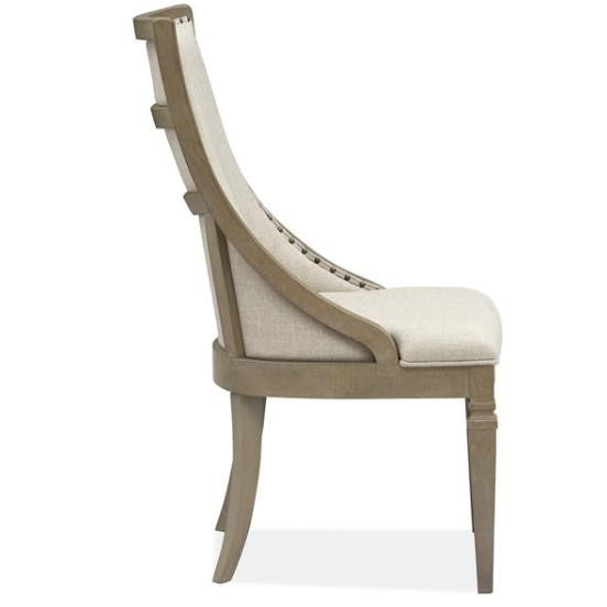 Side view of a beige upholstered chair with wooden frame.