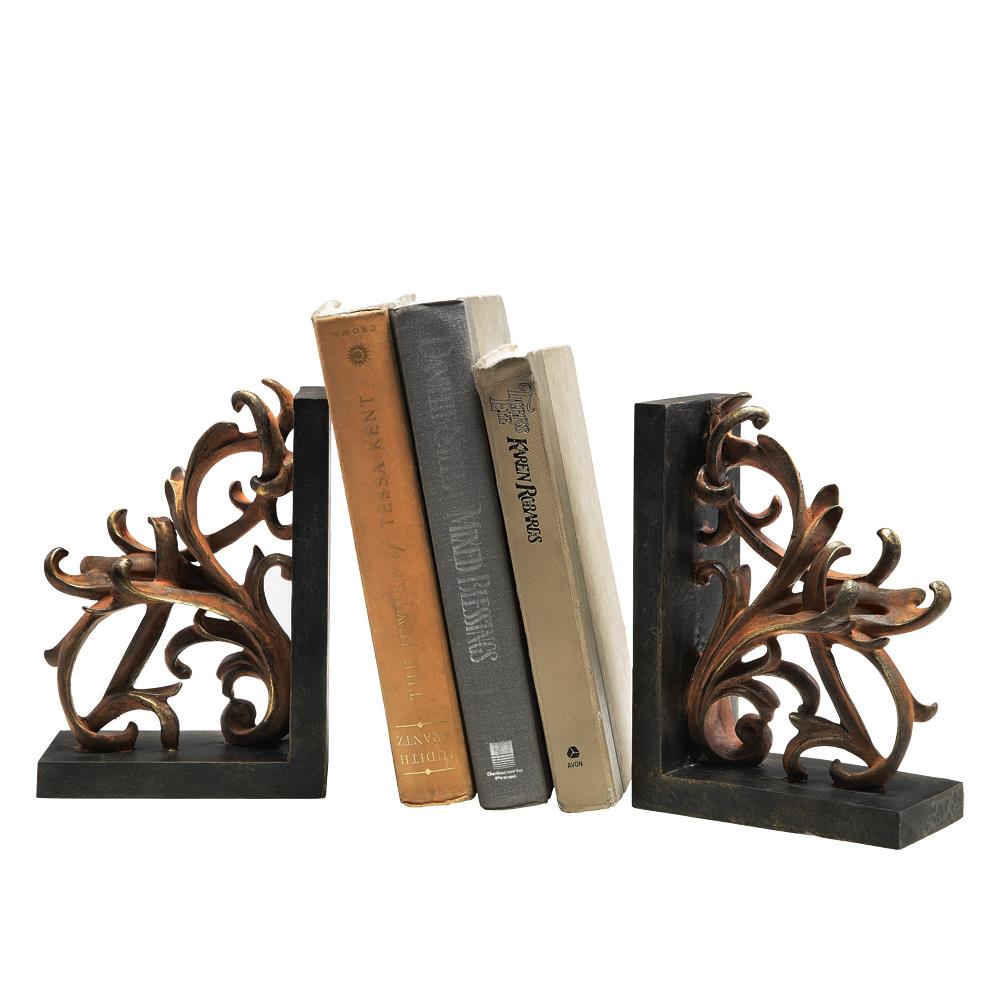 Books between ornate bookends with floral designs.