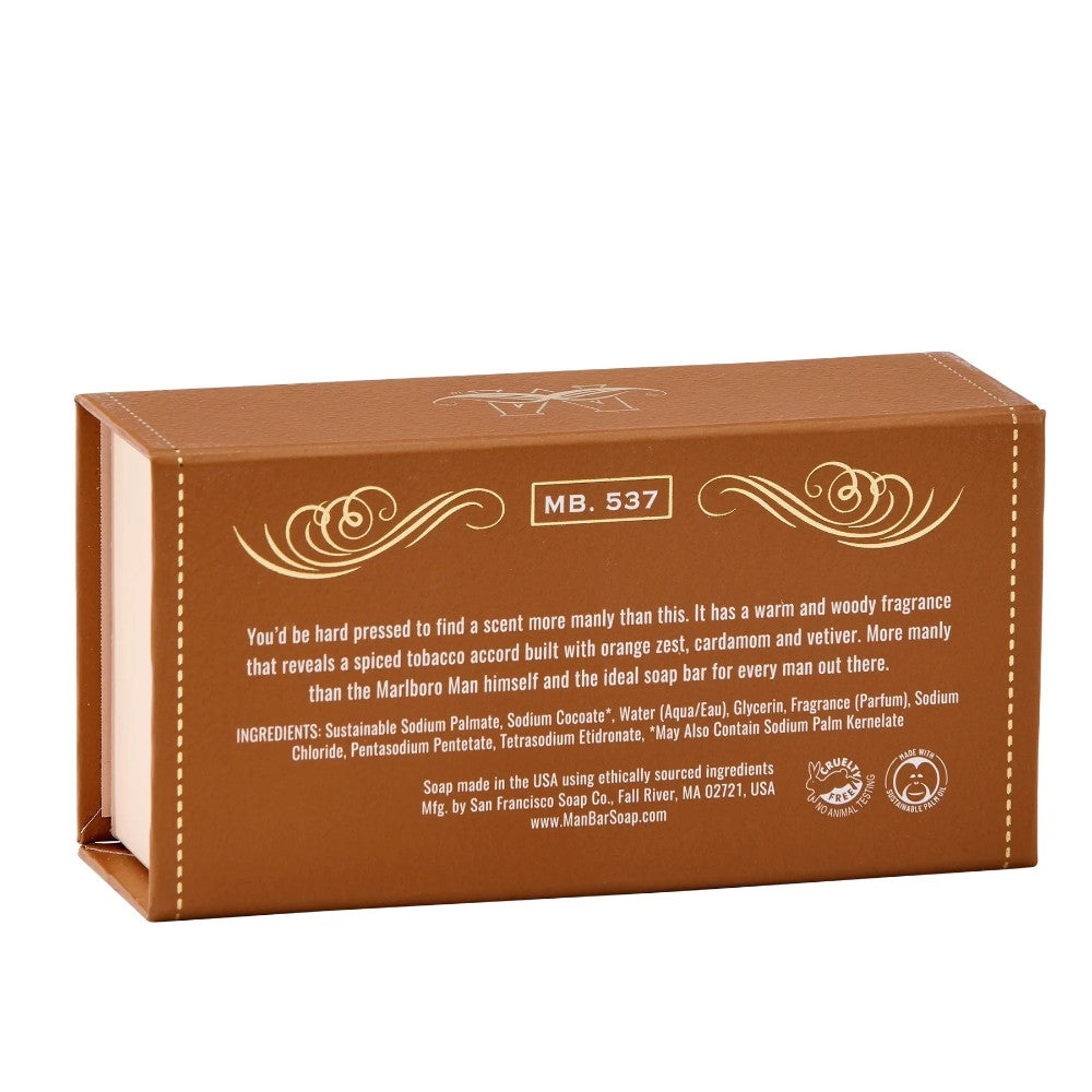 Brown soap box with decorative swirls and text describing a woody fragrance.