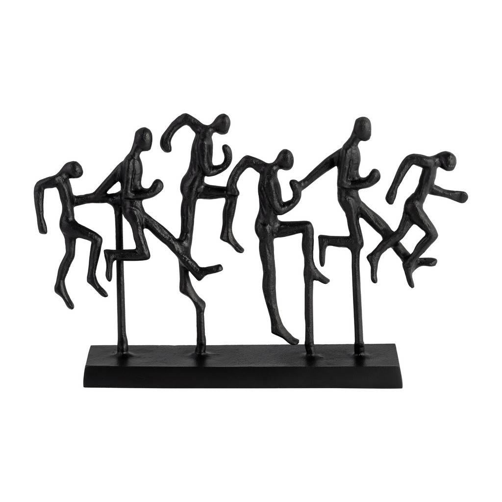 Sculpture of abstract figures jumping energetically.