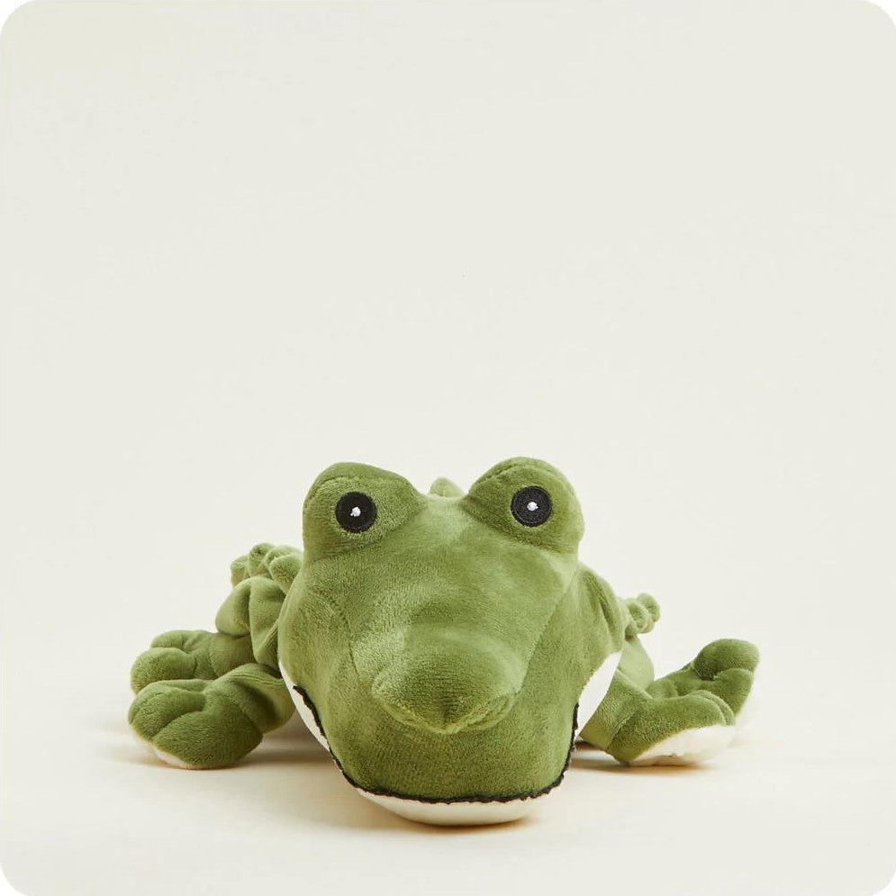 Plush green crocodile toy on a light background.