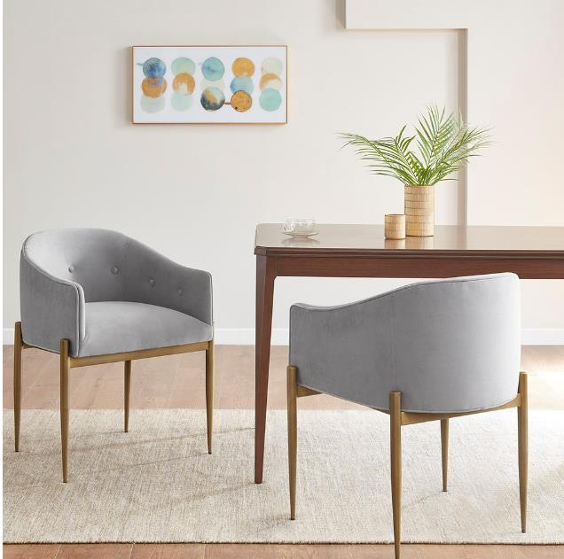 Modern dining area with gray chairs and stylish decor.