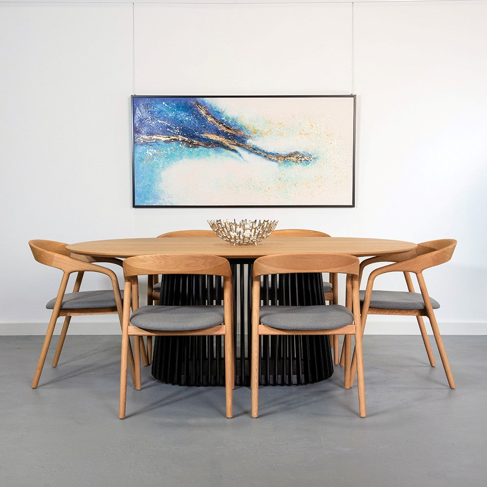 Modern dining set with abstract painting above.