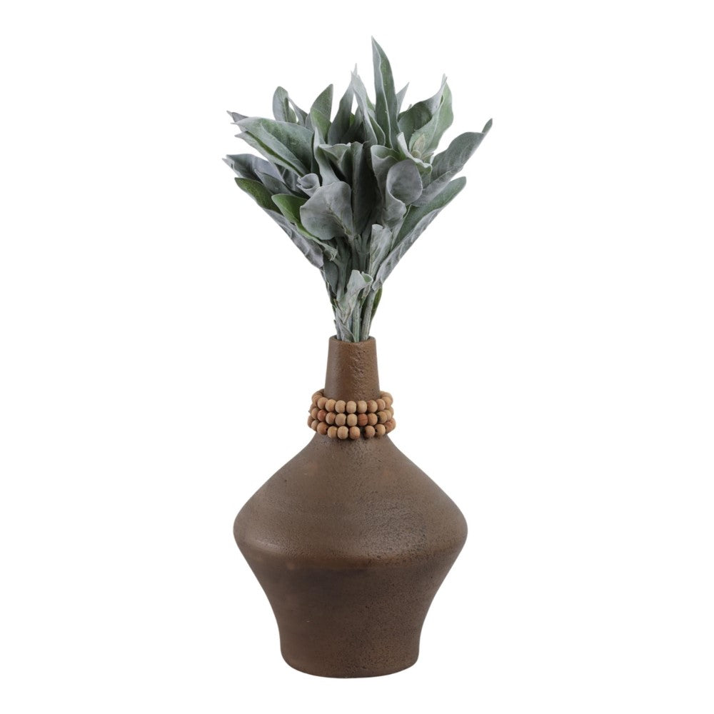 Brown vase with leafy greens and a wooden bead accent.
