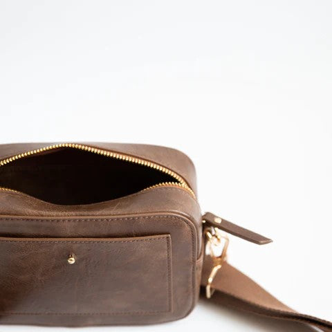 Brown leather crossbody bag with a zipper and open pocket.