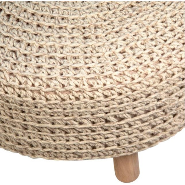 Round knitted ottoman with wooden leg, beige color.
