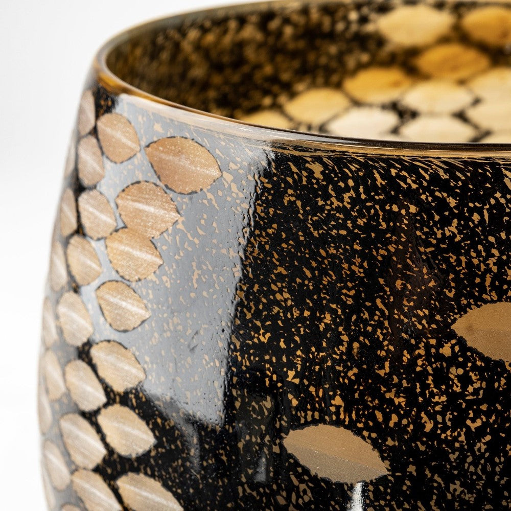 Black and gold-patterned bowl with leaf-like shapes.