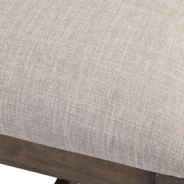 Textured beige fabric on wooden furniture.