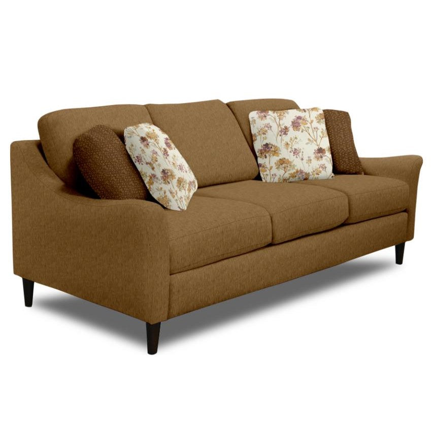 Brown sofa with floral and textured cushions.