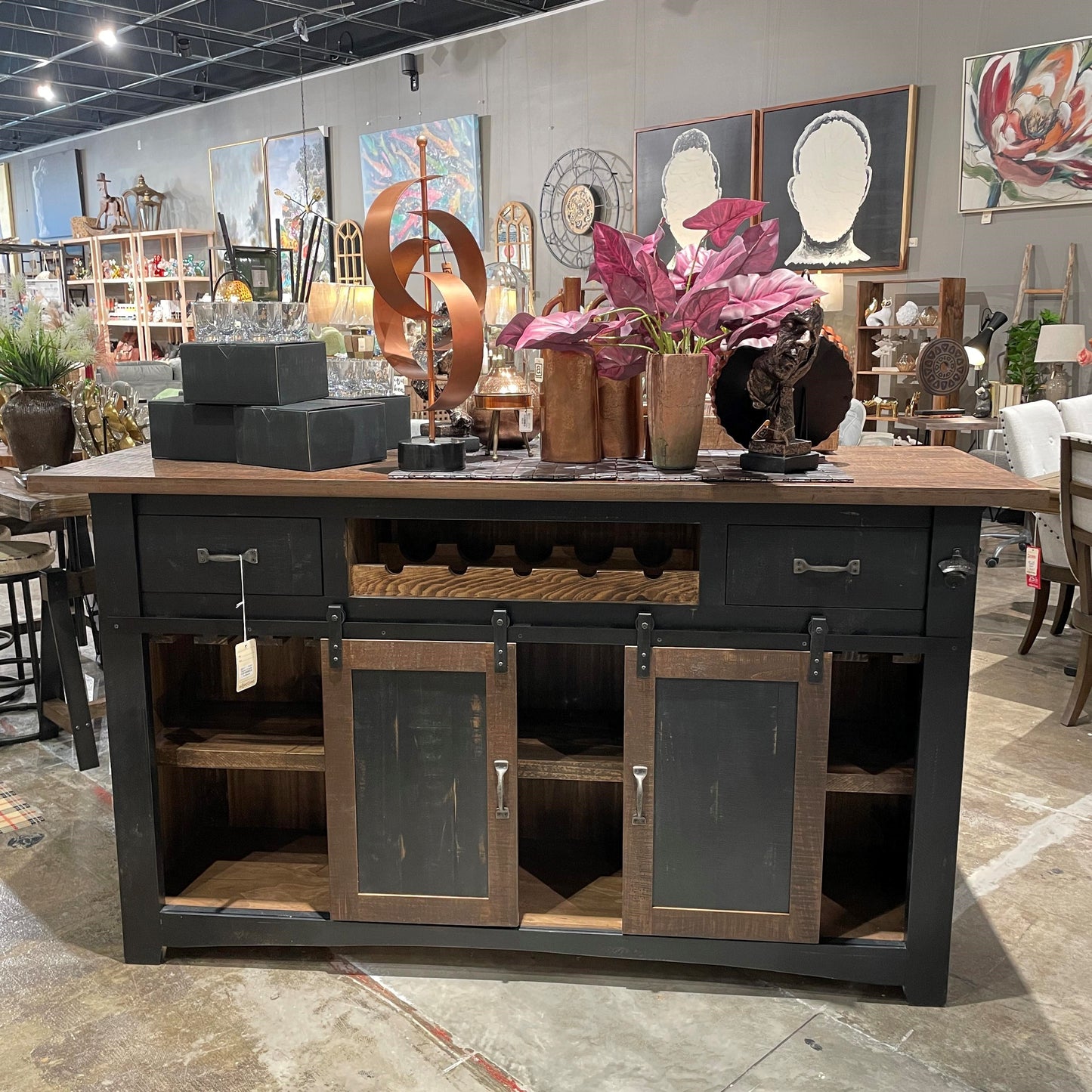 Rustic cabinet with decor items and art displayed in a shop setting.