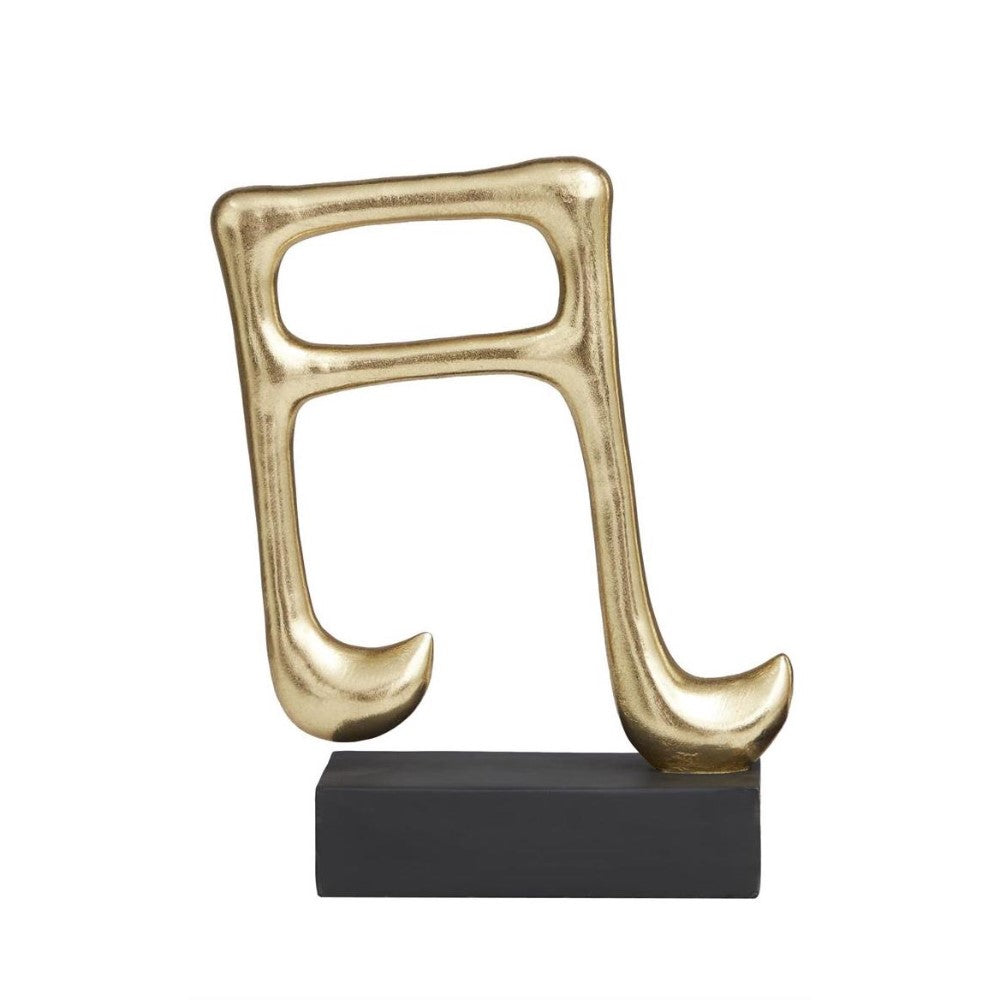 Gold musical note sculpture on black base.