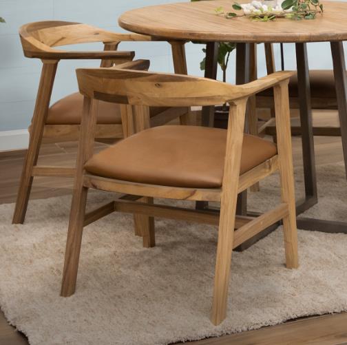 Wooden chairs around a round table on a soft rug.