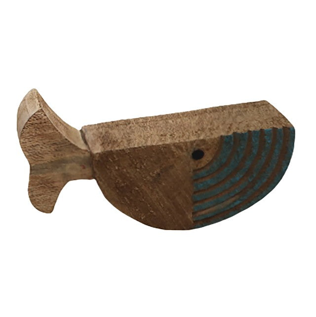Wooden whale carving with blue stripes and a minimalist design.