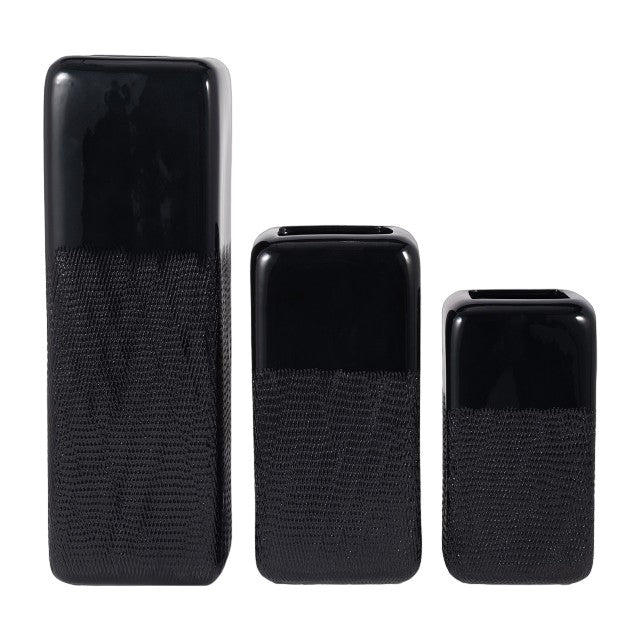 Three black rectangular vases, varying heights.