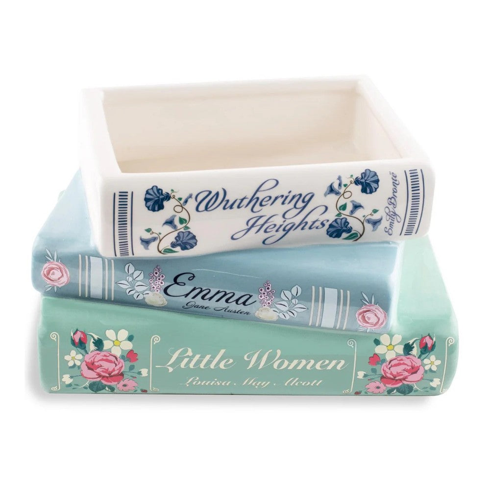 Stacked book-shaped decorative containers with floral designs.
