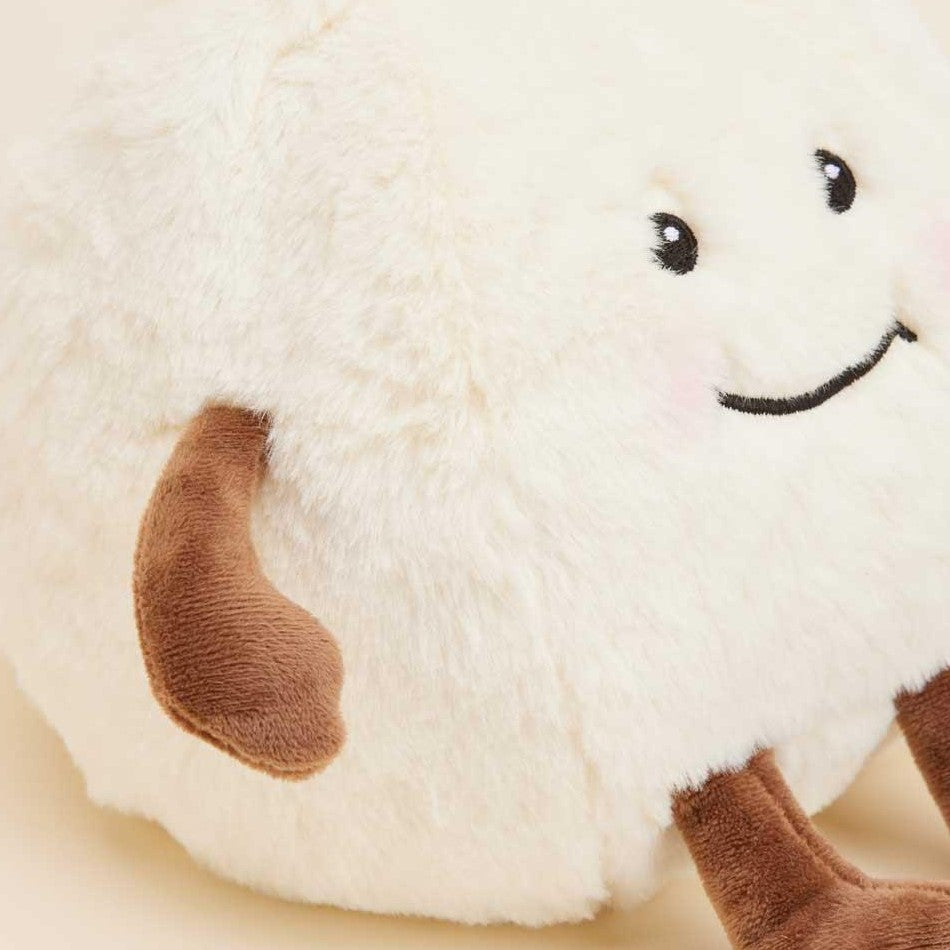Fluffy plush toy with a smiling face and brown limbs.