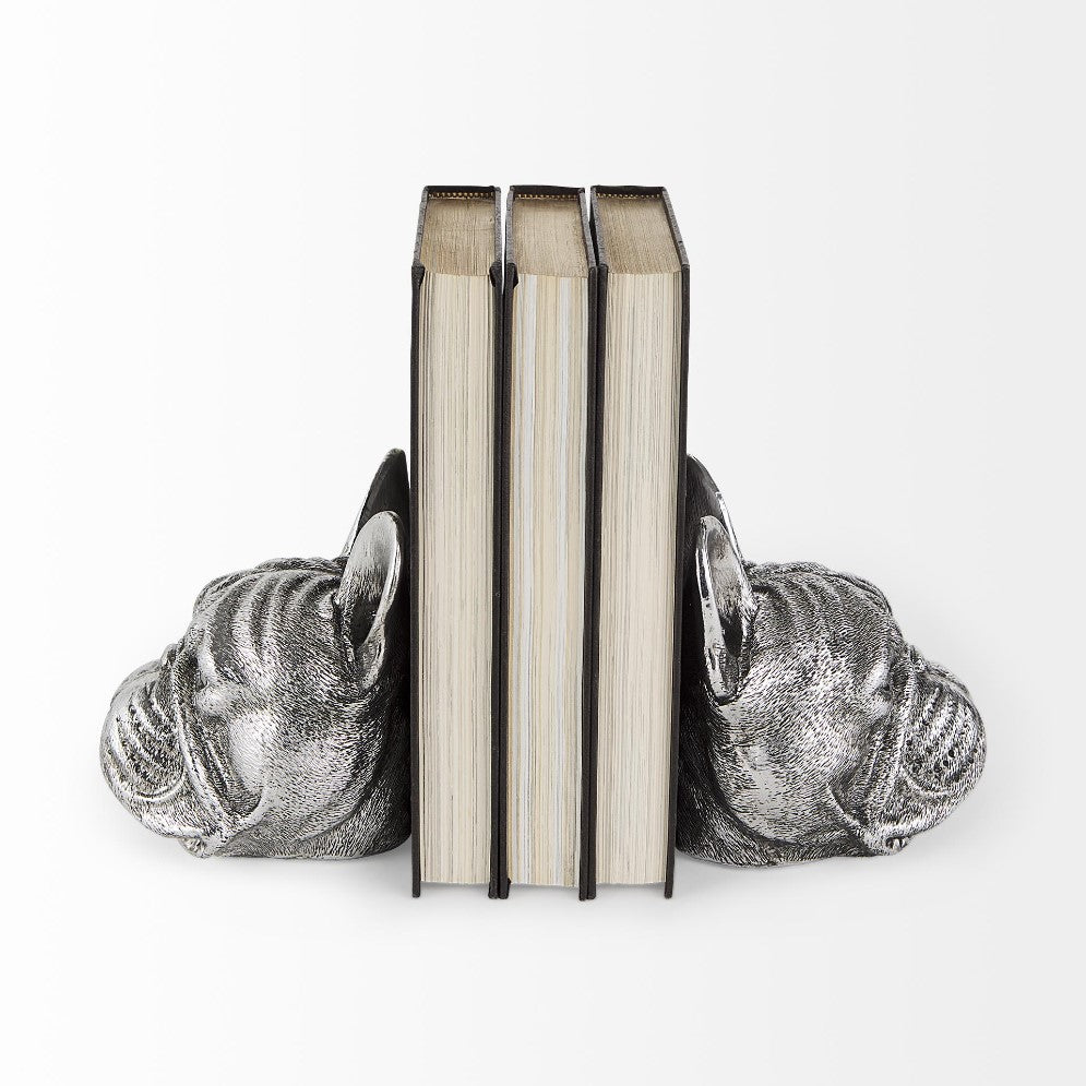 Books held by bulldog-shaped silver bookends.