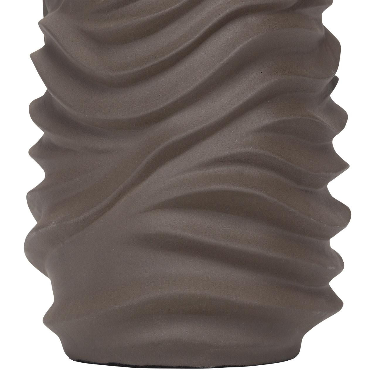 Curved, wave-like texture on a gray surface.