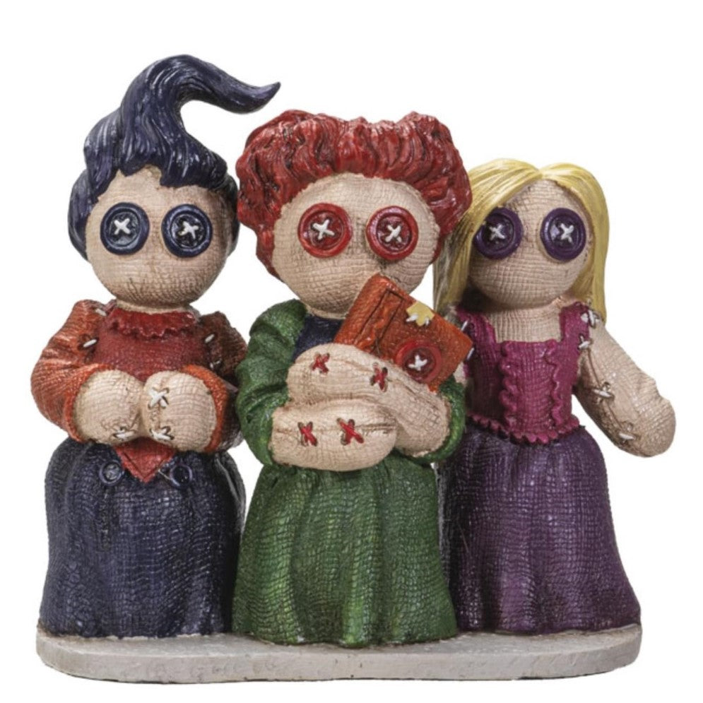 Trio of doll figures with button eyes and colorful outfits.