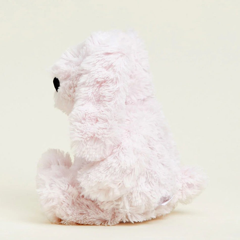 Fluffy white teddy bear sitting sideways.