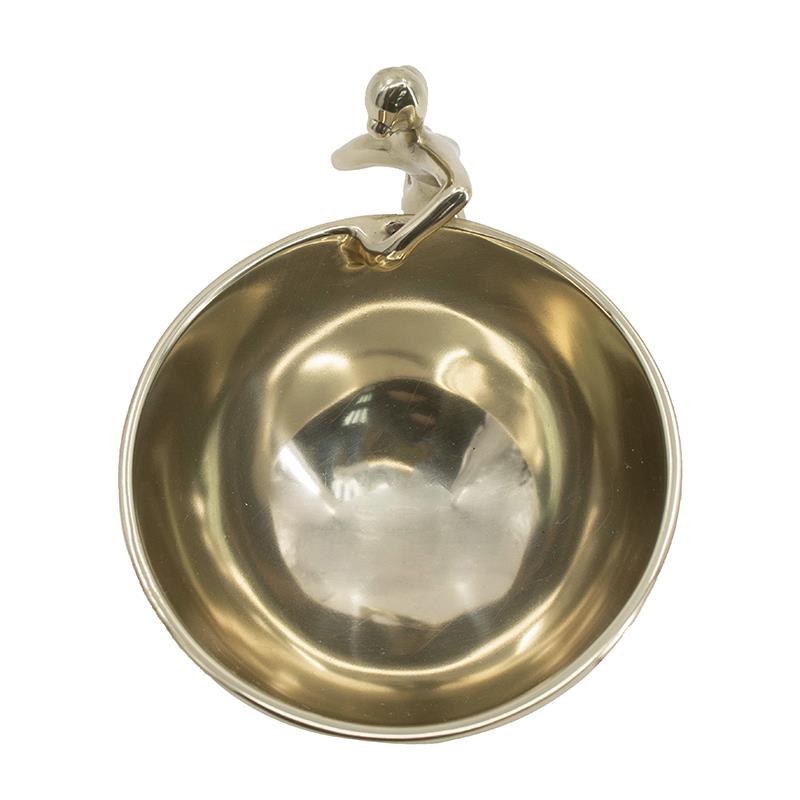 Golden bowl with a figurine handle on the rim.